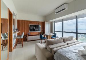 a living room with a couch and a table and chairs at Tropical executive vista Rio in Manaus