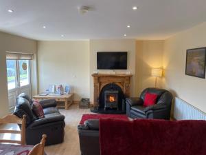 a living room with two chairs and a fireplace at Molly's Self Catering Accommodation in Cavan