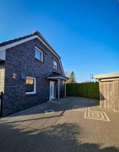 a house with a driveway in front of it at Haus Katja in Büdelsdorf