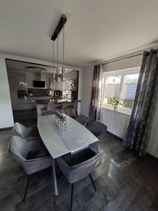 a kitchen and dining room with a table and chairs at Haus Katja in Büdelsdorf