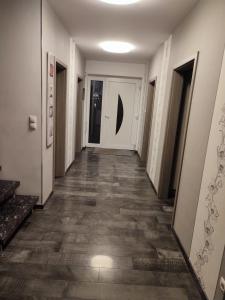 a hallway of a building with white walls and wooden floors at Haus Katja in Büdelsdorf