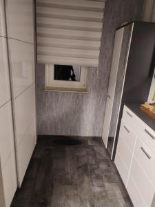 a small kitchen with a window in the wall at Haus Katja in Büdelsdorf +17 photos