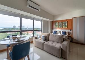 a living room with a couch and a table at Tropical executive vista Rio in Manaus