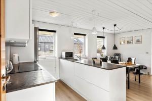 a kitchen with white cabinets and a counter top at 347-Harboore-Slettevej-71 in Harboør