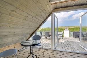 a view from the deck of a house with a table and chairs at 347-Harboore-Slettevej-71 in Harboør