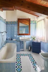 a blue and white bathroom with a tub and a sink at Dream's hill in San Pietro di Feletto +48 photos