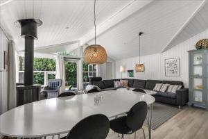a living room with a white table and chairs at G195-Lemvig-Porsevej-95 in Lemvig