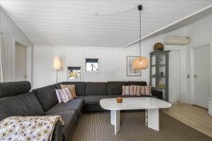 a living room with a couch and a table at G195-Lemvig-Porsevej-95 in Lemvig