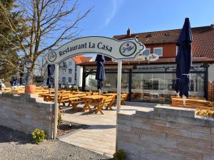 a restaurant la casa with tables and umbrellas at La Casa Motel in Schaafheim