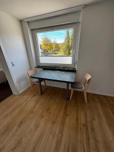 a room with a table and a large window at Karla in Torgelow