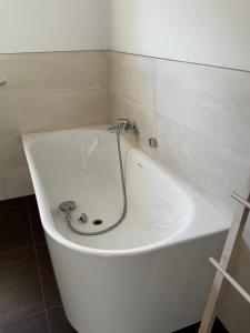 a white bath tub with a faucet in a bathroom at Karla in Torgelow