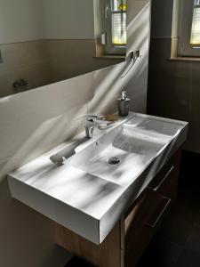 a white sink in a bathroom with a mirror at Karla in Torgelow +3 photos