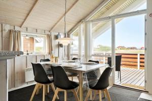 a dining room with a table and some chairs at 511-Lemvig-Lyngsletten-13 in Lemvig