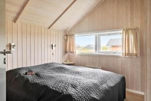 a bedroom with a bed and a window at 511-Lemvig-Lyngsletten-13 in Lemvig