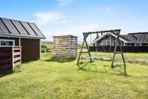 a swing in a yard next to a house at 511-Lemvig-Lyngsletten-13 in Lemvig