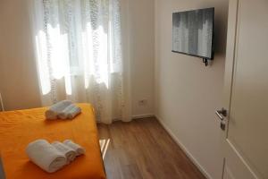 two towels on a bench in a room with a window at MB House in Sistiana