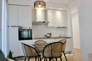 a kitchen with a table and chairs in a room at MB House in Sistiana