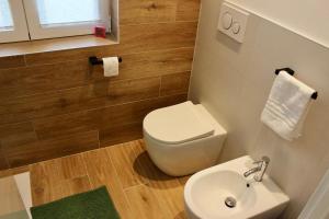 a bathroom with a toilet and a sink at MB House in Sistiana +6 photos