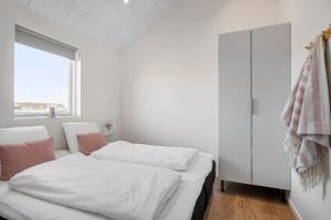 a white room with two beds and a window at 373-Harboore-Slettevej-45 in Harboør