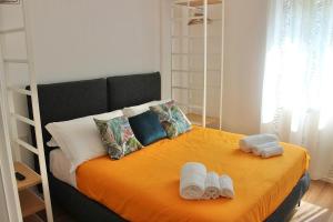 a bedroom with a bed with towels on it at MB House in Sistiana