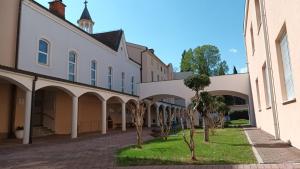 a row of buildings with trees in the courtyard at Paxora sobe - Mostar in Mostar