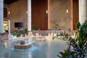 a fountain in the lobby of a hotel at Grand Palladium Select Bávaro - All Inclusive in Punta Cana