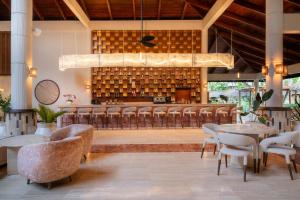 a restaurant with chairs and tables and a bar at Grand Palladium Select Bávaro - All Inclusive in Punta Cana