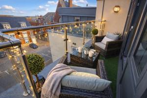 a balcony with chairs and a table on a balcony at Margate Penthouse Private Balconies Sea Glimpses Gated Parking Air-Con The Penthouse Margate in Margate