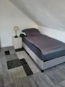 a bedroom with a bed and a lamp on a floor at Appartement Ferienwohnung in Hövelhof