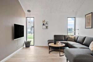 a living room with a couch and a table at 371-Harboore-Fourmivej-6 in Harboør