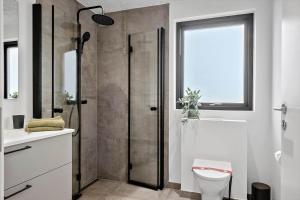 a bathroom with a shower and a toilet and a sink at 371-Harboore-Fourmivej-6 in Harboør +20 photos