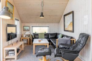 a living room with a couch and a table at 374-Harboore-Fourmivej-15 in Harboør