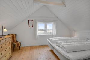a white bedroom with a bed and a window at 526-Lemvig-Rubyvej-21 in Lemvig