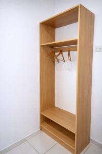 a wooden wardrobe in a room at Bonno Guest Suite in Gaborone