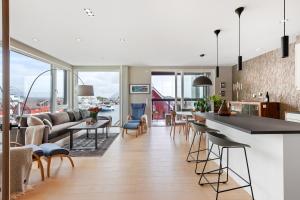 a kitchen and living room with a view of the harbor at Svolvær Panorama City Suite in Svolvær