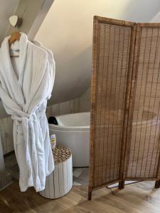 a bathroom with a bath tub and a towel at L'Orée du Mont proche du mont saint Michel in Pontorson +78 photos