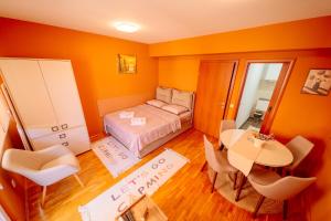 a bedroom with a bed and a table and chairs at Stan na dan DM Uzice in Užice