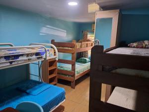 a dorm room with several bunk beds in it at Hostel Archimedes in Paramaribo
