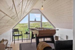 a room with a ping pong table in a tiny house at VK233-Harboore-Doblervej-83 in Harboør