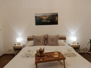a bedroom with a bed with a tea kettle on it at Vacanze Mariu' in Porto Empedocle