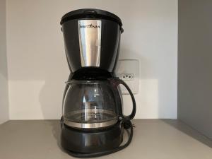 a black blender sitting on top of a counter at Manaíra Apart Hotel in João Pessoa
