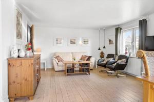 a living room with a couch and two chairs at 704-Thyboron-Kirkevej-6 in Thyborøn