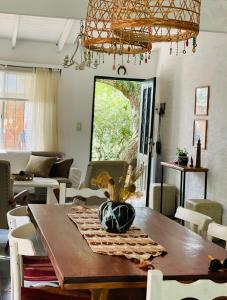 a dining room with a wooden table and chairs at Casa Sua in Victoria