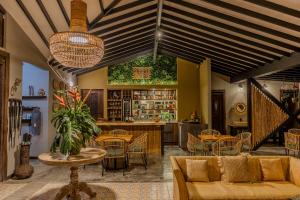 a restaurant with tables and chairs and a bar at Tukki Ecolodge Hotel in Filandia