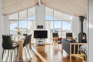 a living room with a table and chairs and a tv at 519-Lemvig-Gaskaervej-95-h in Lemvig