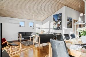 a dining room and living room with a table and chairs at 519-Lemvig-Gaskaervej-95-h in Lemvig