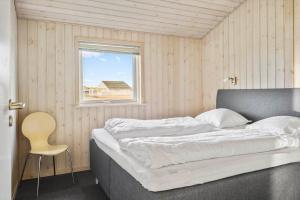 a large bed in a room with a window at 519-Lemvig-Gaskaervej-95-h in Lemvig