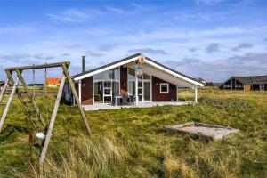 a small house in a field with a playground at 519-Lemvig-Gaskaervej-95-h in Lemvig
