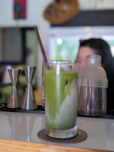 a drink sitting on a counter next to a jar of liquid at Happy Hope Khao San in Bangkok