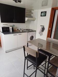 a kitchen with a table and a stove top oven at Charmant studio au rez de chaussée in Arbois